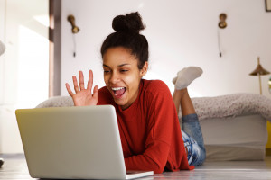 Smiling woman making video call on laptop